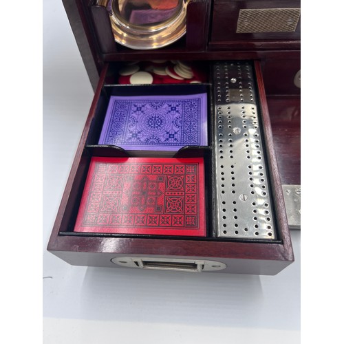 1274A - An Edwardian mahogany inlaid cut glass tantalus and games box containing cigar cutter, silver plated... 