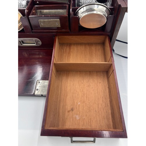 1274A - An Edwardian mahogany inlaid cut glass tantalus and games box containing cigar cutter, silver plated... 