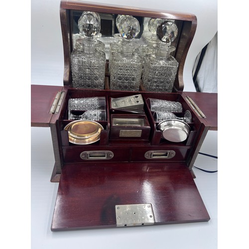 1274A - An Edwardian mahogany inlaid cut glass tantalus and games box containing cigar cutter, silver plated... 