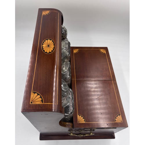 1274A - An Edwardian mahogany inlaid cut glass tantalus and games box containing cigar cutter, silver plated... 