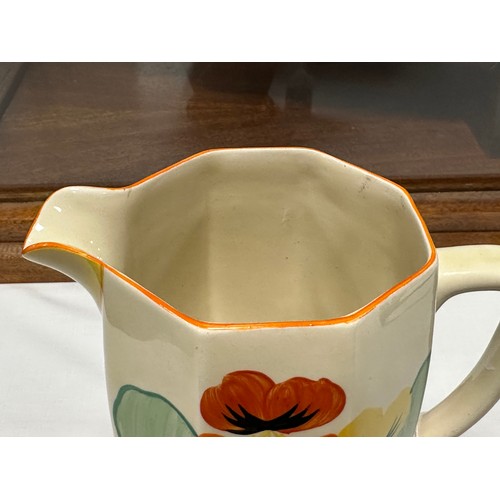 274 - A Clarice Cliff Bizarre Nasturtium pattern jug. 18cm h.