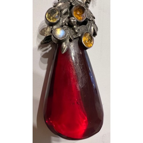 375 - White metal mounted cherry amber drop pendant the mount set with gems to include moonstones. Weight ... 