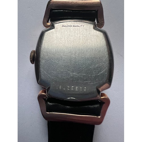 553 - A 10ct gold filled bezel vintage Westfield (Bulova) wristwatch on black leather strap. Case 25mm. 

... 