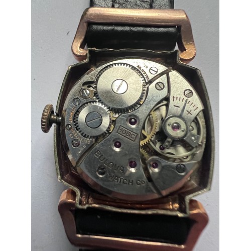 553 - A 10ct gold filled bezel vintage Westfield (Bulova) wristwatch on black leather strap. Case 25mm. 

... 