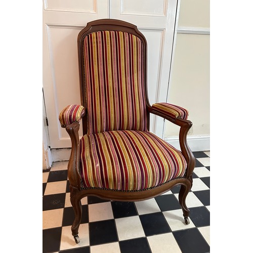 70 - A French mahogany high back armchair with upholstered seat, back and arms, front cabriole legs and c... 