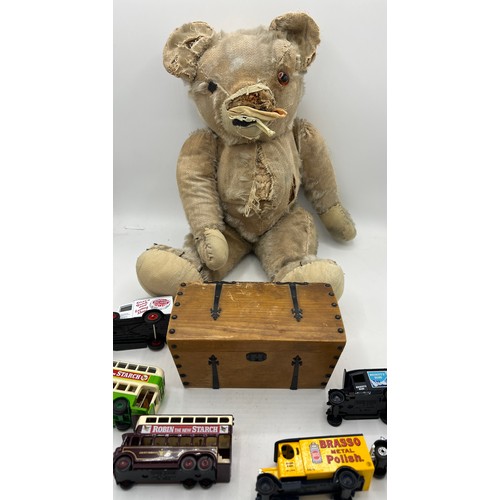 851 - A vintage well loved teddy bear, 48cm h, various Lledo Days Gone advertising vehicles and a music bo... 