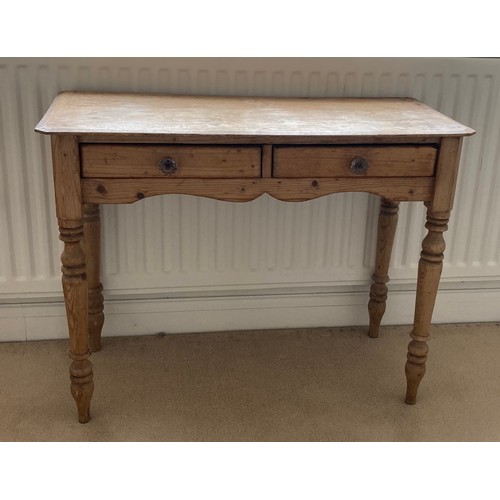 63 - A 19thC pine side table with two drawers to front. 97cm w x 43cm d x 74cm h.