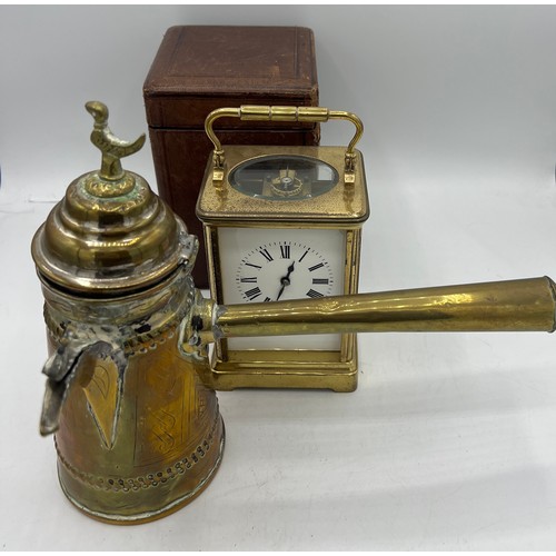 A brass cased carriage clock with French movement in original leather ...