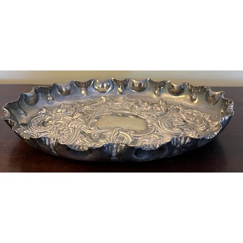 696 - A oval embossed silver dish, Sheffield 1896, maker Fenton, Russell & Co. Ltd. 24.5cm x 17.5 cm. Weig... 