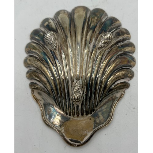 699 - Silver shell shaped dish raised on three shell feet. Birmingham 1887, maker S. Blanckensee & Sons. 1... 