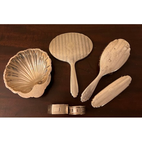 707 - Silver to include shell shaped dish, Chester 1911, maker Barker Brothers, two napkin rings and silve... 