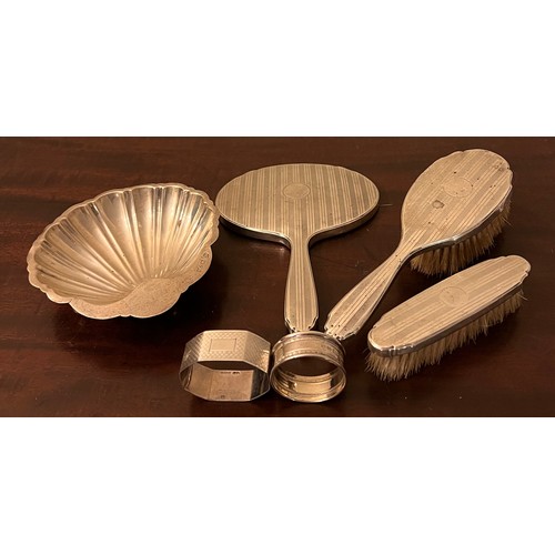 707 - Silver to include shell shaped dish, Chester 1911, maker Barker Brothers, two napkin rings and silve... 