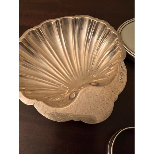 707 - Silver to include shell shaped dish, Chester 1911, maker Barker Brothers, two napkin rings and silve... 