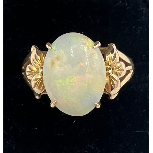 447 - An opal ring mounted in 14 carat yellow gold. Size R. Weight 4gm.