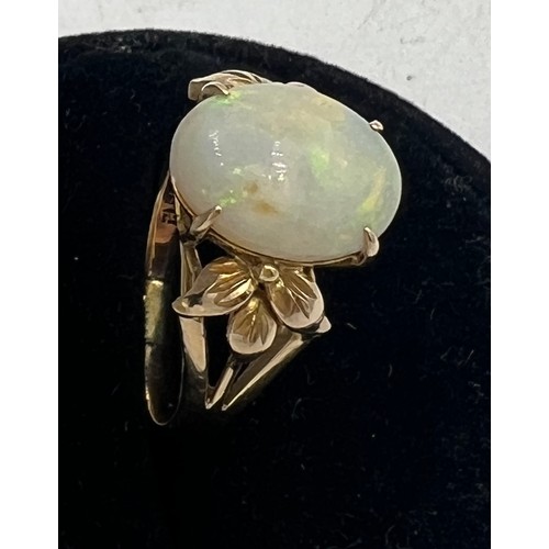 447 - An opal ring mounted in 14 carat yellow gold. Size R. Weight 4gm.