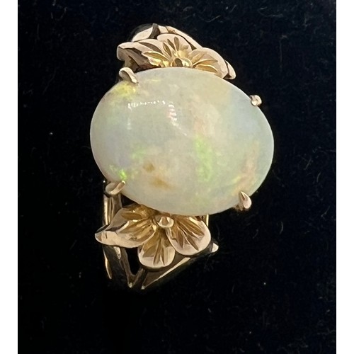 447 - An opal ring mounted in 14 carat yellow gold. Size R. Weight 4gm.