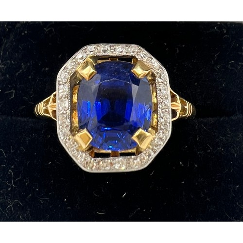 449 - A sapphire and diamond ring mounted in 18 carat gold and platinum. Size N/O. Weight 4.3gm. The cushi... 