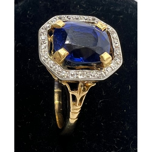 449 - A sapphire and diamond ring mounted in 18 carat gold and platinum. Size N/O. Weight 4.3gm. The cushi... 