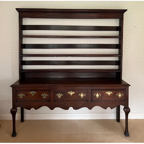 74 - An 18thC oak dresser and rack with fretted base and three drawers. 183cm w x 44cm d x 201cm h.