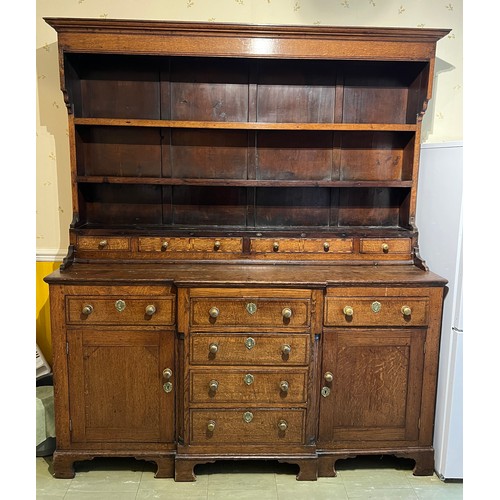 76 - Georgian oak dresser with break front base on bracket feet, four central drawers flanked by two cupb... 