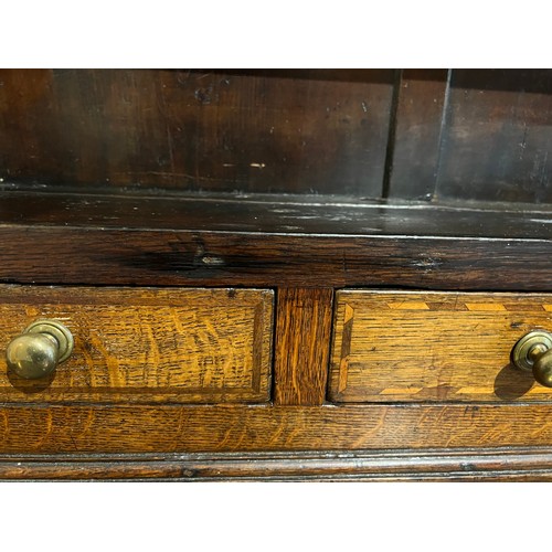 76 - Georgian oak dresser with break front base on bracket feet, four central drawers flanked by two cupb... 