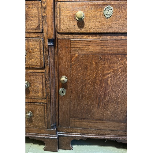 76 - Georgian oak dresser with break front base on bracket feet, four central drawers flanked by two cupb... 