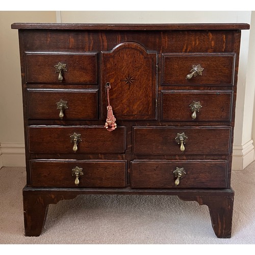 81 - Small oak chest with central door flanked by dummy drawers with others beneath. 63cm w x 44cm d x 64... 