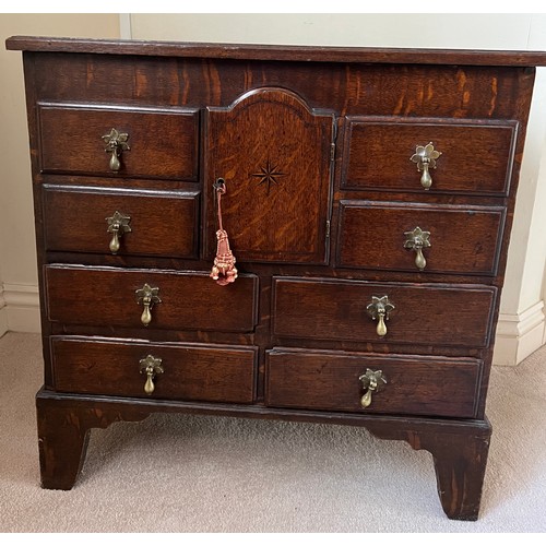 81 - Small oak chest with central door flanked by dummy drawers with others beneath. 63cm w x 44cm d x 64... 