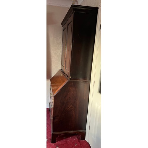 82 - An 18thC mahogany bureau bookcase with candle slides and original brass furnishings. 204cm h x 102cm... 