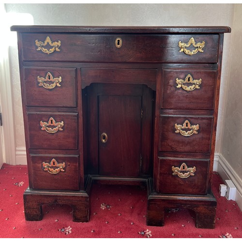 83 - An 18thC mahogany kneehole desk. 77cm h x 76cm w x 45cm d.