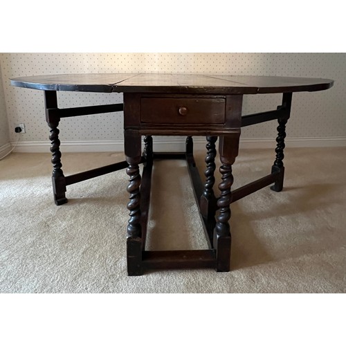 86 - An 18thC oak drop leaf dining table with double twist to the legs and drawer to each side. 74cm h x ... 