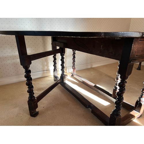 86 - An 18thC oak drop leaf dining table with double twist to the legs and drawer to each side. 74cm h x ... 