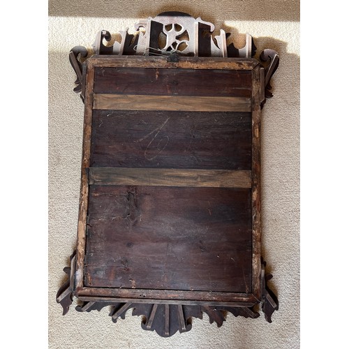 1014 - A mahogany and gilt fretwork wall mirror with phoenix crest.  84cm h x 55cm w.