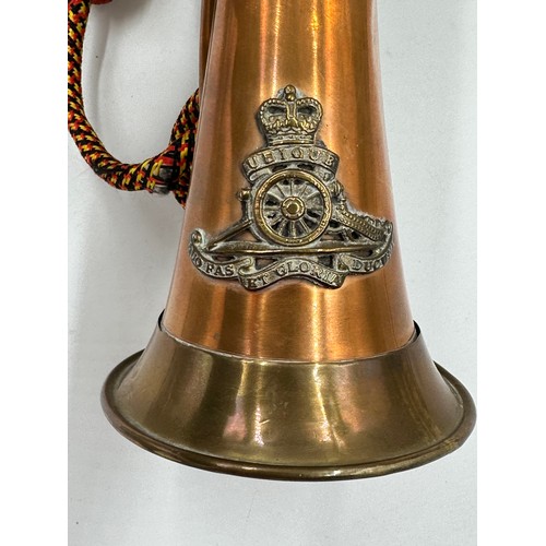 916 - A British Army Royal Artillery brass and copper bugle with yellow, black and red cord tassel and Roy... 