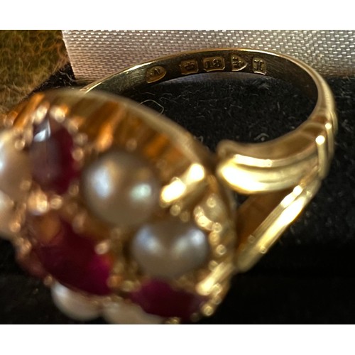 461 - An 18 carat gold ring set with rubies and split pearls. Size M/N. Weight