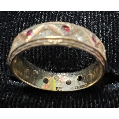 455 - A 9 carat gold eternity ring set with pink and clear stones. Size L, weight 2.2gm.