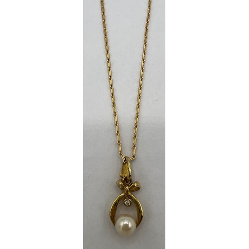 456 - A 9 carat gold cultured pearl and diamond pendant on a 9 carat gold chain. Chain 40cm l.