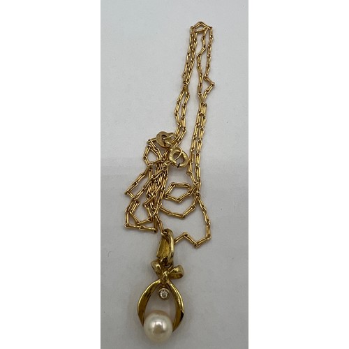 456 - A 9 carat gold cultured pearl and diamond pendant on a 9 carat gold chain. Chain 40cm l.