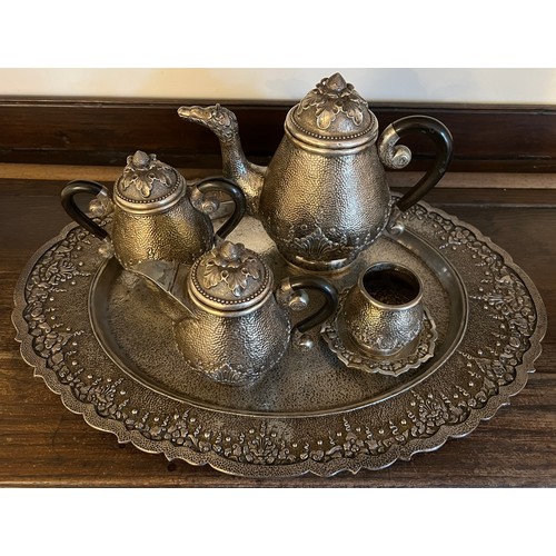 714 - An Indonesian ? white metal teaservice comprising tray, teapot, milk, sugar and container with stand... 