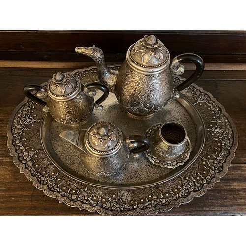 714 - An Indonesian ? white metal teaservice comprising tray, teapot, milk, sugar and container with stand... 