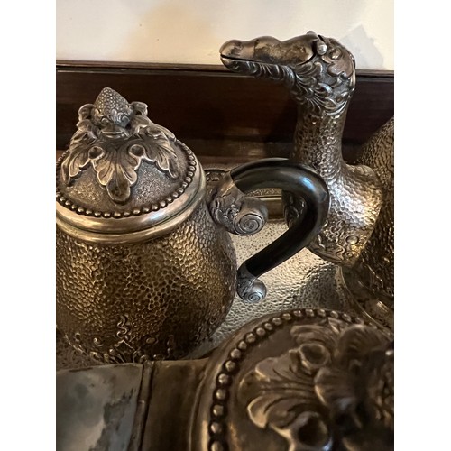 714 - An Indonesian ? white metal teaservice comprising tray, teapot, milk, sugar and container with stand... 