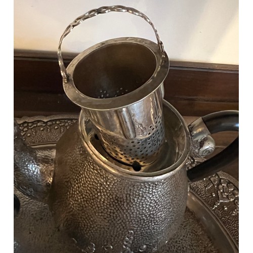 714 - An Indonesian ? white metal teaservice comprising tray, teapot, milk, sugar and container with stand... 