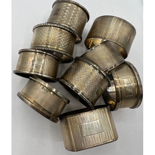 711 - Nine hallmarked silver napkin rings, various dates and makers. Total weight 176gm.