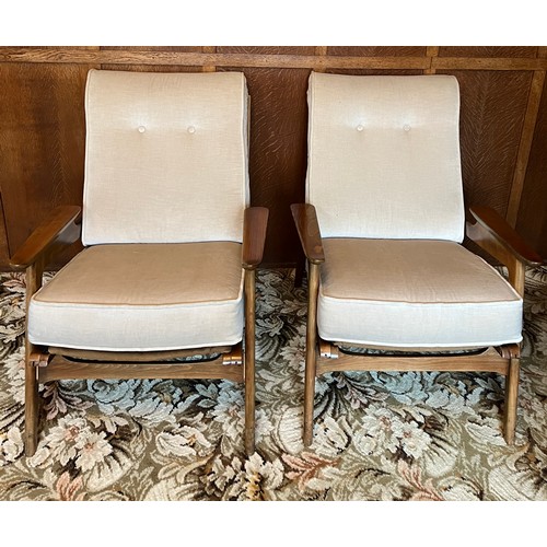 90 - A pair of teak mid 20thC armchairs. Height to back 84cm.