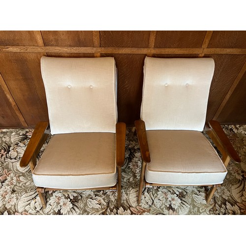 90 - A pair of teak mid 20thC armchairs. Height to back 84cm.