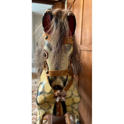 849 - Mid 20thC wooden painted rocking horse. 122cm l x 40cm w.