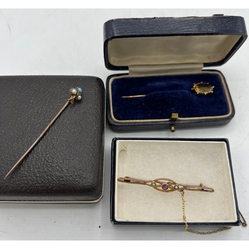 463 - A 15 carat gold tie pin set with seed pearl and turquoise, a yellow metal tie pin set with citrine a... 