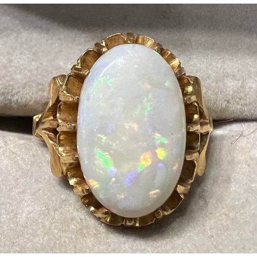 470 - An oval opal in claw setting in yellow metal, tests as 22 carat  gold. Size J, weight 5.5gm.
Opal 15... 