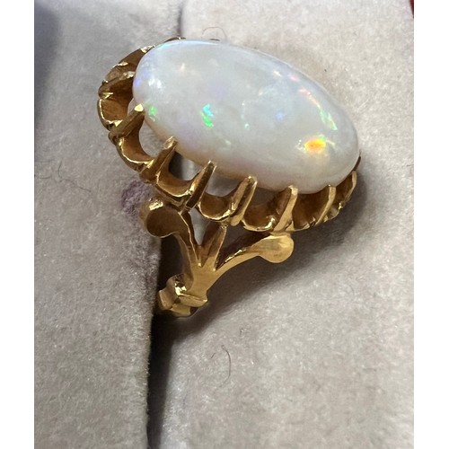 470 - An oval opal in claw setting in yellow metal, tests as 22 carat  gold. Size J, weight 5.5gm.
Opal 15... 