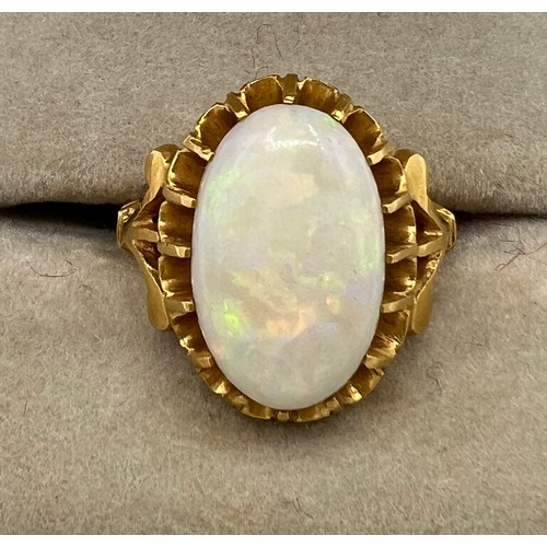 470 - An oval opal in claw setting in yellow metal, tests as 22 carat  gold. Size J, weight 5.5gm.
Opal 15... 